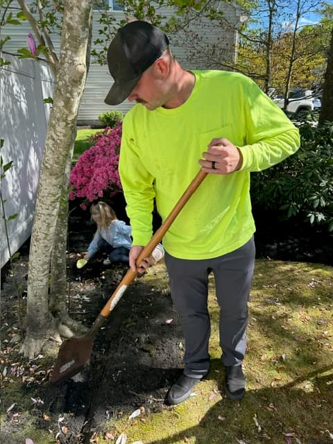 Tyler Warker of T.W. Outdoor Services digging a spring garden bed in Northfield, NJ