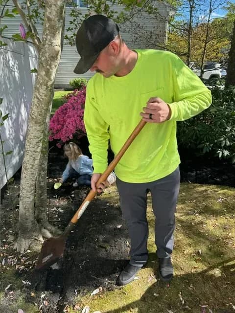 Tyler Warker of T.W. Outdoor Services digging a spring garden bed in Northfield, NJ