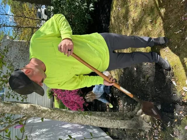 Tyler Warker of T.W. Outdoor Services digging a spring garden bed in Northfield, NJ