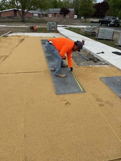T.W. Outdoor Services crew member setting the first course of pavers in Galloway, NJ