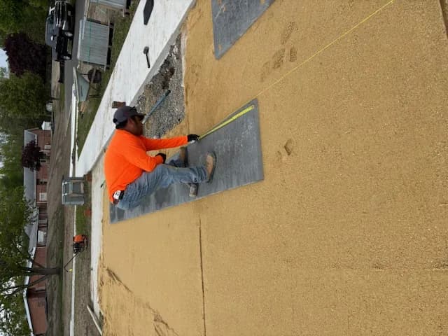 T.W. Outdoor Services crew member setting the first course of pavers in Galloway, NJ