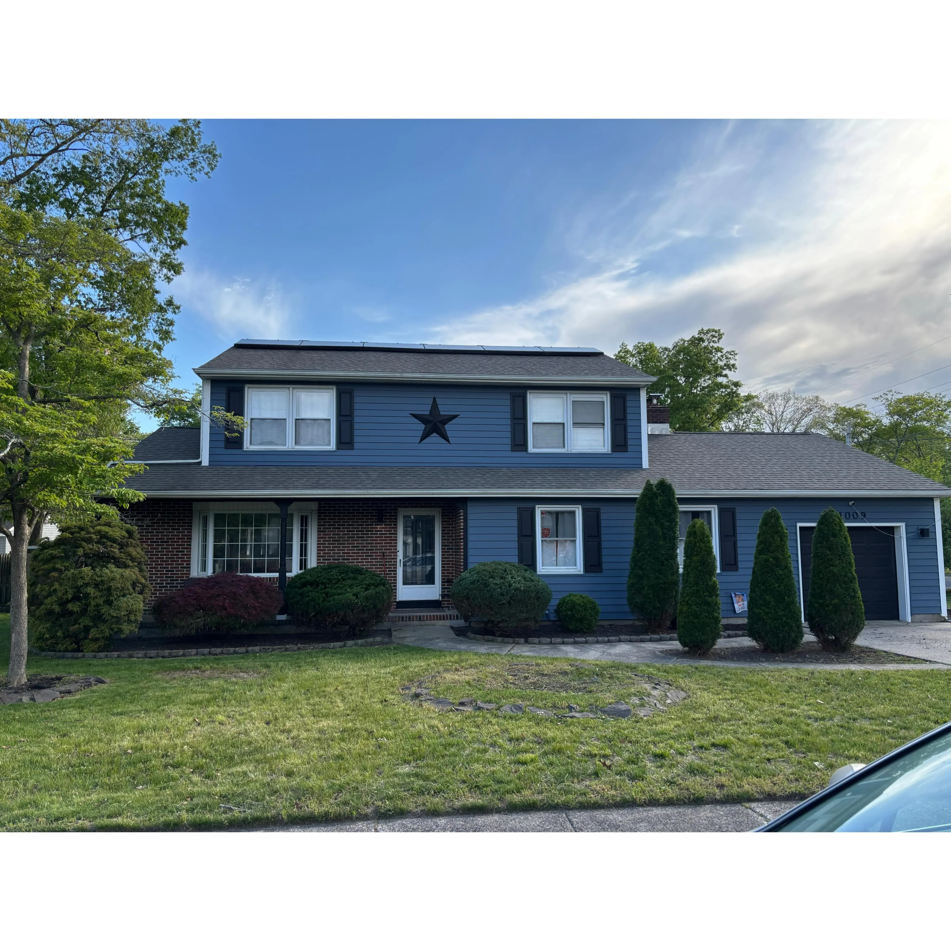 Finished front yard of a blue colonial after a full renovation in Egg Harbor Township, NJ